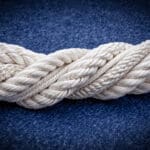 Eén wit gevlochten touw als metafoor voor fusie tot één nieuwe organisatie